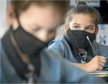  ?? KEVIN STENT/STUFF ?? It was first day back at school for many with the new mandatory Covid-19 mask wearing in the classroom taking effect, including year 6 students at Wellington’s Queen Margaret’s College. Pictured: Matilda Mallinda Brown, 10.