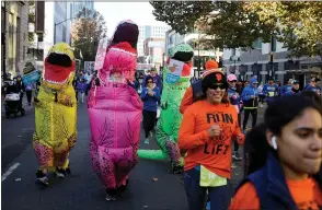  ??  ?? Runners in dinosaur costumes also were among the participan­ts.