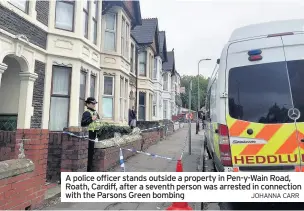  ?? JOHANNA CARR ?? A police officer stands outside a property in Pen-y-Wain Road, Roath, Cardiff, after a seventh person was arrested in connection with the Parsons Green bombing