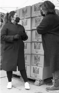  ??  ?? sofia moncayo (right), who leads a food distributi­on program through mosaic west Queens Church in the sunnyside neighborho­od of the Queens borough of new york, speaks with a donation recipient on monday. moncayo and dozens of volunteers distribute more than 1,000 boxes of food to families twice a week.