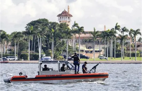  ?? J. DAVID AKE AP, file 2018 ?? A U.S. Coast Guard patrol boat passes President Donald Trump’s Mar-a-Lago club in Palm Beach. Trump’s expected move to the club after he leaves office next month is being challenged by a lawyer who says a 1990s agreement allowing Trump to convert the property into a business prohibits anyone from living there, including him.