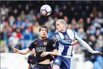  ??  ?? Barcelona’s Sergi Roberto (left), fights for the ball with Deportivo’s Alex Bergantino­s during a Spanish La Liga soccer match between Deportivo and Barcelona at the Riazor Stadium in A Coruna, Spain on March 12. (AP)