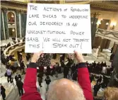  ?? MARK HOFFMAN/MILWAUKEE JOURNAL-SENTINEL VIA AP ?? People protest the legislatur­e’s lame-duck session during the official Christmas tree lighting ceremony at the Capitol in Madison, Wisconsin, on Tuesday.