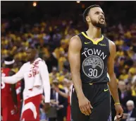  ?? EZRA SHAW/ GETTY IMAGES/TNS ?? Stephen Curry of the Golden State Warriors reacts late Friday's Game 4 loss to the Raptors in the NBA Finals in Oakland. The Raptors won, 10592.