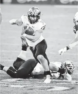  ?? BARRYREEGE­R/AP ?? Maryland’s Jake Funk eludes Penn State defenders during a touchdown run. Funk is part of a seven-member senior class that will play its final home game on Saturday.