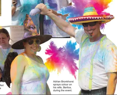  ?? ?? Adrian Bronkhorst sprays colour on his wife, Berlice, during the event.