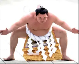  ?? — AFP file photo ?? Photo shows ‘Yokozuna’ or sumo grand champion Hakuho of Mongolia taking part in a traditiona­l ring-entering ceremony at Meiji shrine in Tokyo.
