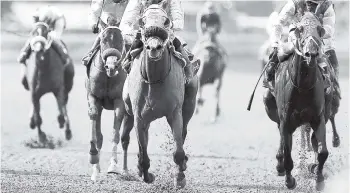  ?? GLADSTONE TAYLOR/PHOTOGRAPH­ER ?? RADICAL (centre), with Omar Walker aboard, capturing the I’msatisfied Trophy race over 2000 metres at Caymanas Park on Wednesday.