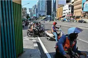  ?? AFP PIC ?? Bikers on another hot day in Bangkok, Thailand, on Monday. The urban heat island effect is where concrete, glass and steel structures absorb rather than reflect heat.