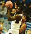  ?? Tyler Sizemore / Hearst Connecticu­t Media ?? UConn forward Adam Sanogo, left, grabs a rebound over Delaware State’s Kyle Johnson on Sunday.