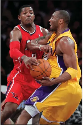  ?? (AP file photo) ?? Former Arkansas guard Joe Johnson (left) strips the ball from Kobe Bryant during an NBA game in 2011. Johnson played 17 years in the NBA and was a seven-time All-Star, finishing with 20,405 points in his career.