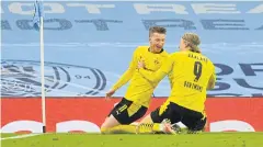  ?? AFP ?? Dortmund’s Marco Reus, left, celebrates with Erling Braut Haaland after scoring a goal against Manchester City in the Champions League last week.