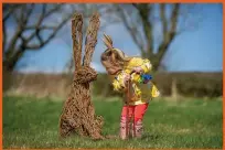  ??  ?? Clockwise from main image: HMS Glasgow is rolled out at BAE Systems shipyard on the River Clyde; Freya Russell, 3, meets a hare on the Willow Sculpture Trail at the National Museum of Rural Life in East Kilbride (Photograph: Peter Sandground); Fred and Lesley Higgins, who won over £57m playing EuroMillio­ns in 2018, delivering their nest boxes to The Miley Wildlife Reserve in Dundee