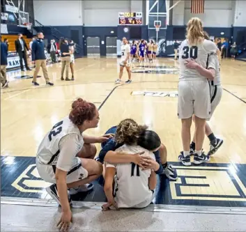  ?? Alexandra Wimley/Post-Gazette photos ?? Rochester players console each other after losing to Bishop Guilfoyle, 55-50, in a PIAA Class 1A girls semifinal Tuesday night at Rochester High School.