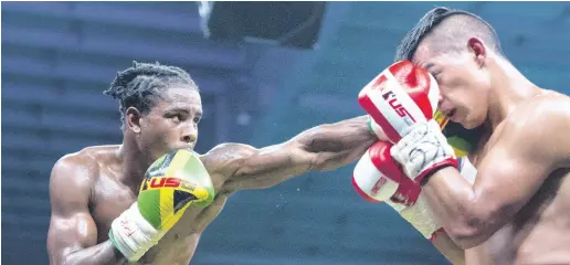  ?? GLADSTONE TAYLOR ?? Richard ‘Frog’ Holmes (left) on the offensive against opponent Ricardo ‘Magic Man’ Salas during the Wray and Nephew Contender final held at National Indoor Sports Centre on Wednesday, July 25, 2018.
