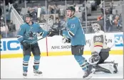  ?? JOSIE LEPE — THE ASSOCIATED PRESS ?? Sharks left wing Matt Nieto and center Nick Bonino (13) celebrate a goal by defenseman Brent Burns (88) in the third period against the Knights in San Jose on Saturday.