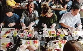  ?? DANA JENSEN/THE DAY ?? Amber Scheetz, center left, of Groton and Coral Crandall, center right, of Norwich share a laugh while making sushi during a class at Pink Basil at Olde Mistick Village in Mystic on May 17. The class was hosted by the Chamber of Commerce of Eastern...