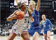  ?? Jessica Hill/Associated Press ?? UConn’s Aaliyah Edwards, left, looks to shoot as Creighton’s Mallory Brake defends during the first half Wednesday in Storrs.