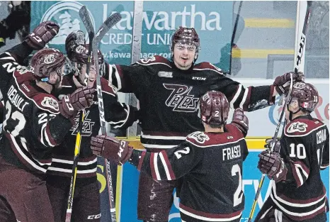  ?? CLIFFORD SKARSTEDT EXAMINER FILE PHOTO ?? The Petes' Max Grondin, middle, celebrates a goal against Saginaw at the Memorial Centre in 2019. Grondin is one of the players strength and conditioni­ng coach Josh Gillam is working with during this COVIDdelay­ed OHL season.