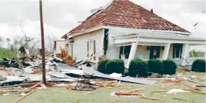  ??  ?? Debris and a damaged house seen following a tornado in Beauregard, Alabama. — Reuters