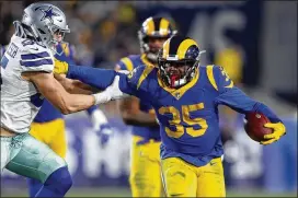  ?? SEAN M. HAFFEY / GETTY IMAGES ?? The Rams’ C.J. Anderson stiff arms Leighton Vander Esch of the Dallas Cowboys in the second half in the NFC Divisional Playoff game on Jan. 12.