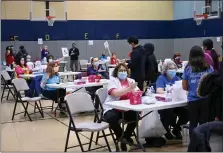  ?? PHOTO COURTESY ALLISON BARTO PHOTOGRAPH­Y ?? Volunteers participat­e in Skippack Pharmacy’s COVID-19booster clinic on Sunday at North Penn High School in Towamencin Township.