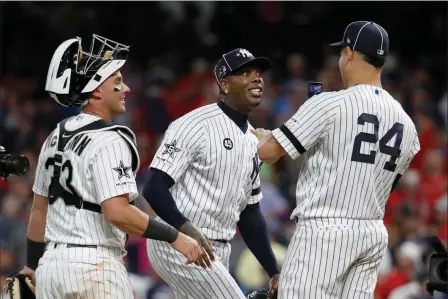  ?? ASSOCIATED PRESS ?? AMERICAN LEAGUE PITCHER AROLDIS CHAPMAN, of the New York Yankees, jokes with teammate Gary Sanchez (24), of the New York Yankees, and James McCann (left), of the Chicago White Sox, after the American League defeated by National League 4-3 in Tuesday’s MLB All-Star Game in Cleveland.