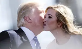  ?? BRENDAN SMIALOWSKI/AFP/GETTY IMAGES ?? President Donald Trump kisses daughter Ivanka in Mandan, North Dakota.