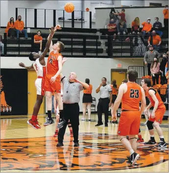  ?? MIKE ECKELS/ WESTSIDE EAGLE OBSERVER ?? Cardinal Caleb Blakely (11) and Lion Tristan Batie (15) tip off at center court to start the Friday night GravetteFa­rmington conference matchup at Lion Arena in Gravette. Brady Hunt picked up the ball for Gravette. Farmington won the with a final score of 64-51.