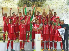  ?? (AFP) ?? Bayern Munich’s players celebrate after defeating Borussia Dortmund on penalties to win the German Super Cup in Dortmund, Germany, on Saturday