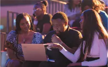  ?? ?? Thulani Pfende from the Mail & Guardian with two members of the audience at the ABH competitio­n.