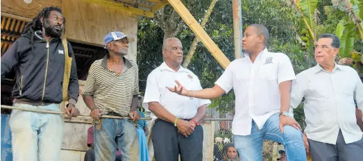  ?? CONTRIBUTE­D ?? Minister of Agricultur­e, Fisheries and Mining Floyd Green (second right) converses with farmers Fabian Stennett (left) and Errol Reid (second left), during a visit to Welcome Hall, St James, on January 17. Looking on are Minister of State in the Ministry of Agricultur­e, Fisheries and Mining, Franklin Witter (centre), and Minister of State in the Office of the Prime Minister (West), Homer Davis.