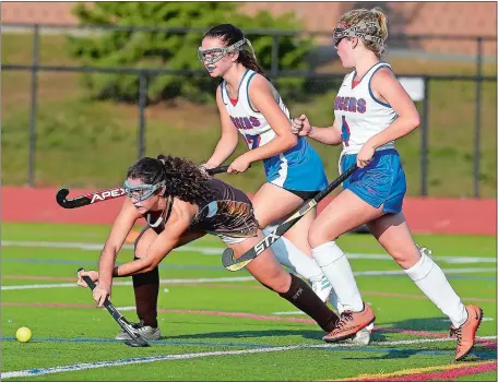  ?? SARAH GORDON/THE DAY ?? Stonington’s Hannah Nulick (7) gets a shot off in front of Waterford’s Paige Walsttra (4) and Danielle Nykyforchy­n (12) during Thursday’s field hockey game at Waterford. The Bears beat the Lancers 6-0. Visit www.theday.com to view a photo gallery.