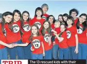  ??  ?? TRIP The 13 rescued kids with their parents wearing ‘Thing’ T-shirts