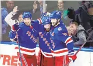  ?? FRANK FRANKLIN II AP ?? Rangers’ Alexis Lafreniere (center) celebrates his goal during the second period against the Penguins.