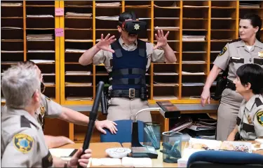  ?? COMEDY CENTRAL ?? “Reno 911!” is back as a Quibi show. Here, Deputy Travis Junior (Robert Ben Garant) tries out virtual reality.