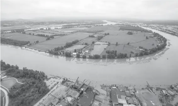  ??  ?? Barnston Island, which is under an evacuation alert due to potential flooding, is seen in an aerial view along the Fraser River.