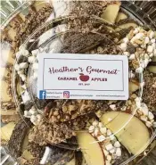  ?? ALEXIS LARSEN / CONTRIBUTE­D ?? Heather’s Gourmet Caramel Apples covers Honeycrisp apples in chocolate and caramel.