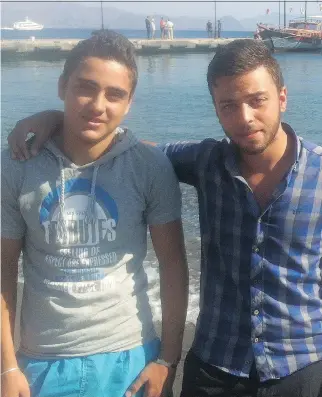  ?? SHANNON GORMLEY/
OTTAWA CITIZEN ?? Amjad and Bashar in Kos on Sunday. Amjad, a Syrian who spent 16 hours adrift at night in the Aegean Sea, finally made it back to shore and caught another boat to Greece, where he rejoined his friend.