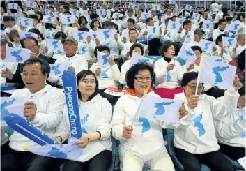  ?? JUNG YEON-JE/GETTY FILES ?? Korean fans waving “unificatio­n flags” as they cheer for North Korean players during the IIHF women’s world ice hockey championsh­ips division II group A competitio­n match between South Korea and North Korea in Gangneung. The two Koreas agreed to march...