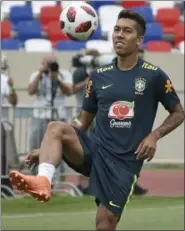  ?? EKATERINA LYZLOVA — THE ASSOCIATED PRESS ?? Brazil’s Roberto Firmino controls the ball during a training session in Sochi, Russia, Wednesday. Brazil will face Belgium on July 6 in the quarterfin­als.
