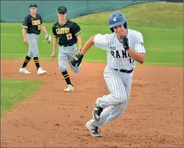  ?? Dan Watson/The Signal (See additional photos on signalscv.com) ?? West Ranch’s Trey Topping runs back to first base after hitting a two-run single in the seventh inning against Canyon at Canyon on Wednesday. Canyon players Brandon Whiting (23) and Gage Holmes (13) stopped Topping as he headed for second base.