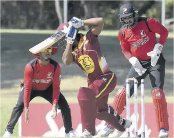  ?? (photo: cwi media/philip spooner) ?? Terrence Warde (centre) is bowled by Sunil Narine(out of picture).