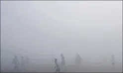  ?? SUNIL GHOSH/HT PHOTO ?? Children playing football amid dense fog at Noida Stadium in Sector 21 A on Thursday. Analysts said pollution levels may further rise on January 31.