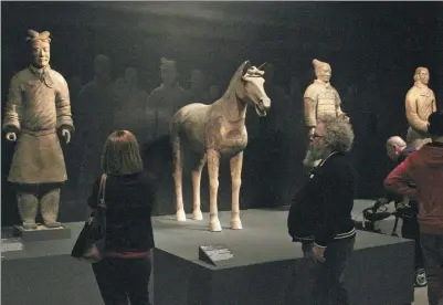  ?? AMY HE / CHINA DAILY ?? Items from a Qin and Han dynasties exhibition go on display on Monday at the Metropolit­an Museum of Art in New York. The exhibition will run through July 16.