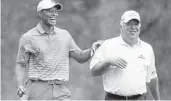  ?? JIM YOUNG/REUTERS ?? It’s like old times as Tiger Woods laughs with friend Mark O’Meara during practice round.