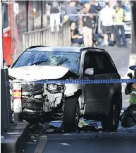  ?? JOE CASTRO / AAP IMAGE VIA AP ?? A damaged vehicle is seen on Flinders Street, in Melbourne Thursday, after a car drove into pedestrian­s on a sidewalk in the Australian city.