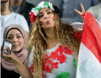  ?? AFP ?? A Syrian fan cheers her team prior to the kickoff of the 2018 World Cup qualifying match against Australia in Sydney. —