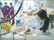  ?? TIAN JIANMING / CHINA DAILY ?? A doctor tends to Liu Guoqun on Wednesday at the No 1 Hospital of Jiaxing, Zhejiang province. Mortally injured in an accident, she was declared brain dead.