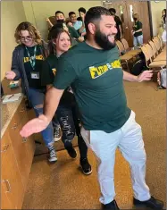  ?? RECORDER PHOTO BY ESTHER AVILA ?? SCHS Principal Martin Medina claps along after getting pulled into a conga line Friday at one of the sessions during the Be Future Ready Conference 2022 aimed at the school’s 136 sophomores.
